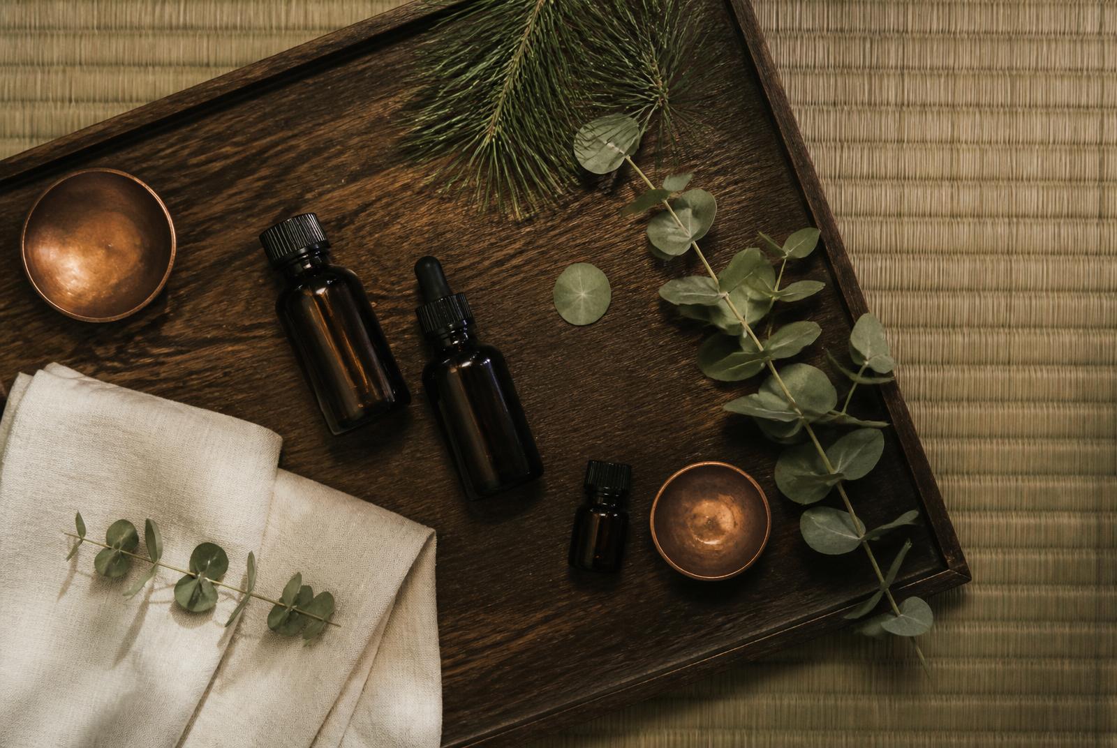 Flacons d'huiles essentielles naturelles utilisées lors d'un massage bien-être pour homme — Nagomi Wellness Strasbourg